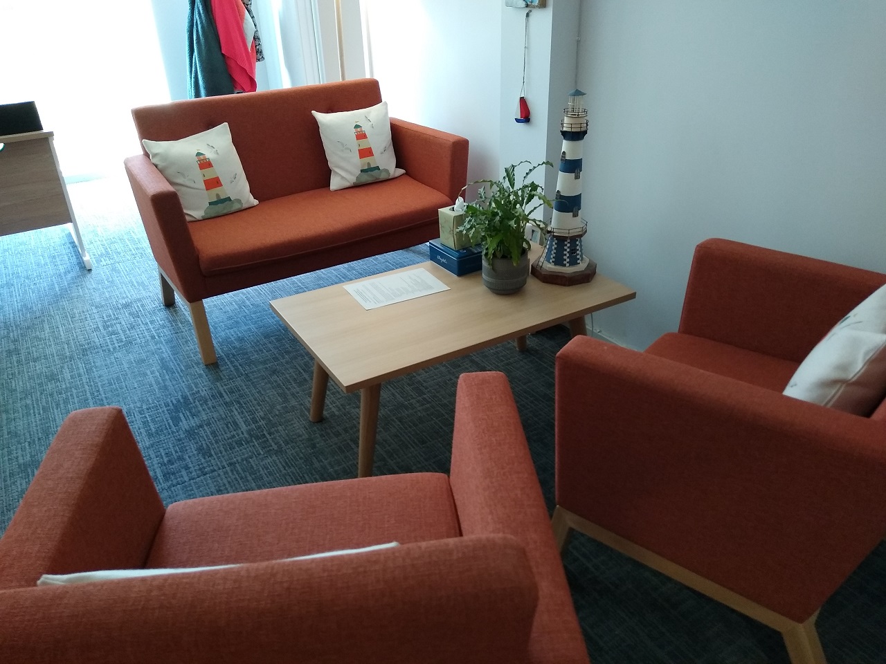An orange sofa and armchairs, homely furnishings
